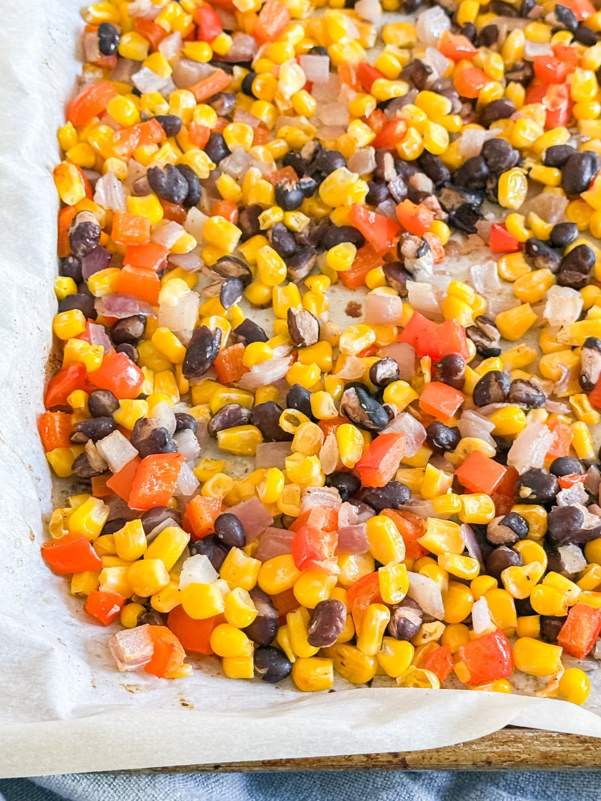 A close up image of the corner of the pan of corn salsa.