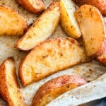 A close up of roasted red potatoes on a pan.