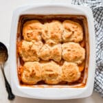 An overhead image of peach cobbler in a pan.