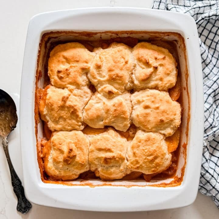 An overhead image of peach cobbler in a pan.