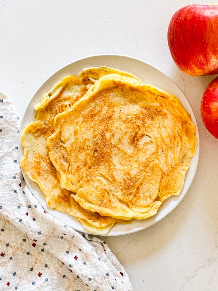 An overhead image of apple pancakes on a plate.