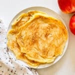 An overhead image of apple pancakes on a plate.