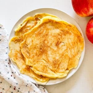 An overhead image of apple pancakes on a plate.