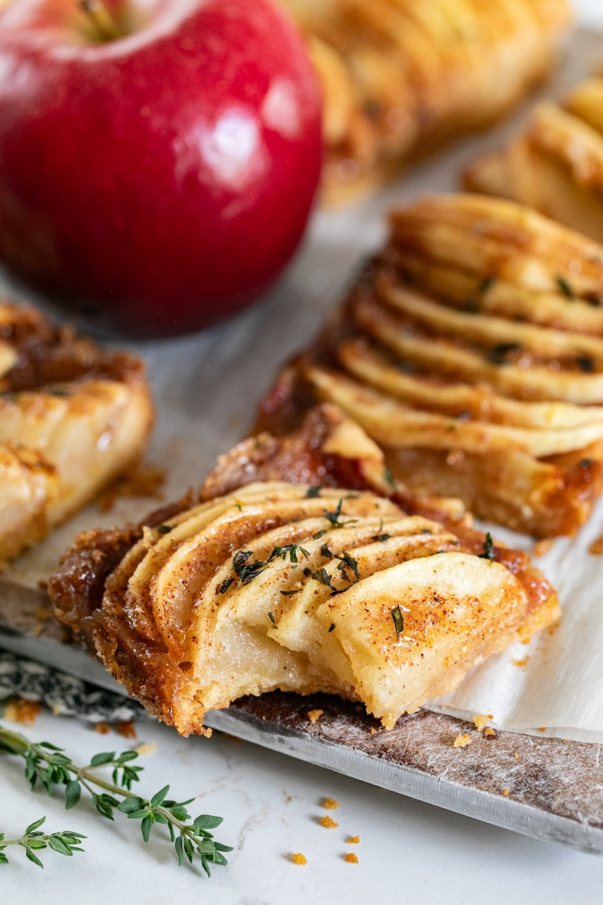 An Apple bar on a cutting board with a bite in it.