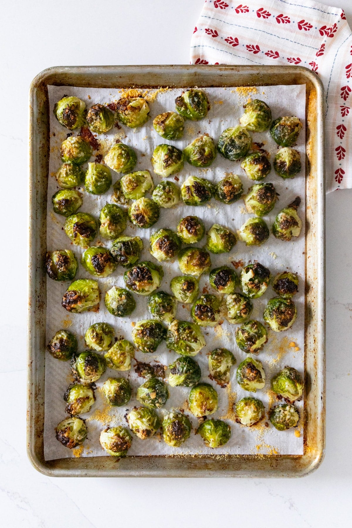 An overhead image of a sheet pan of Parmesan roasted Brussels Sprouts